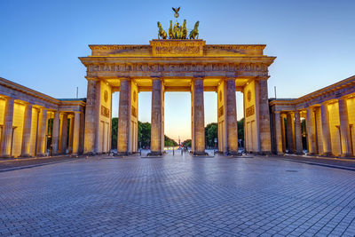 The illuminated brandenburg gate in berlin at twilight with no people