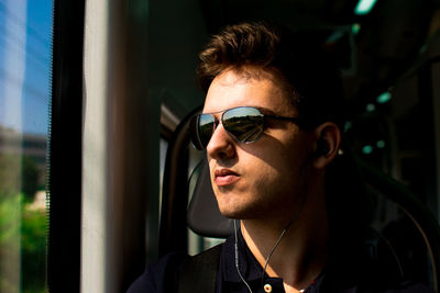 Young man in sunglasses looking away