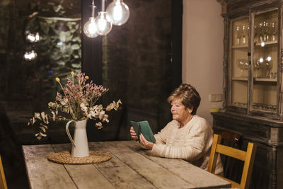 Senior woman using smart phone at home