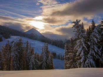 Scenic view of snow covered mountains against sky