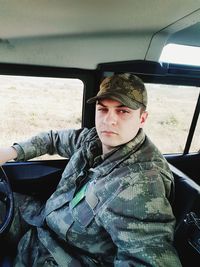 Portrait of army soldier sitting in car