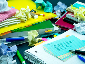 High angle view of text on paper amidst books on table