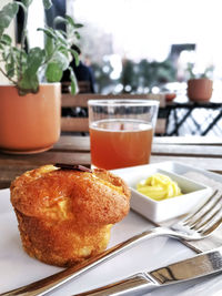 Close-up of muffin in plate on table at cafe