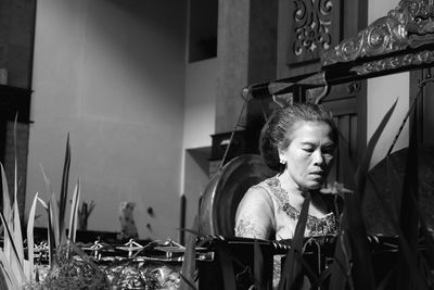 Woman sitting by machinery