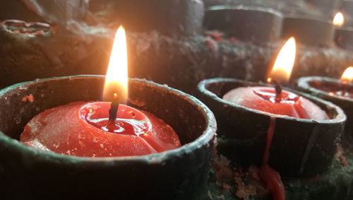 Close-up of burning candles on rock