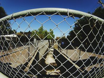 Chainlink fence seen through chainlink fence