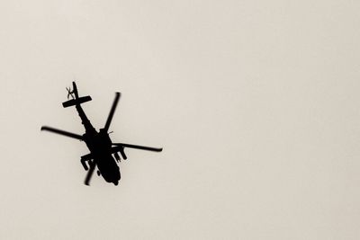 Low angle view of helicopter against clear sky