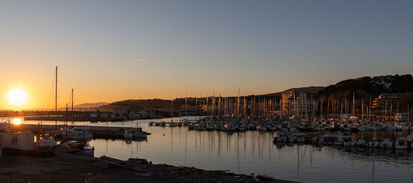 Boats in marina at sunset