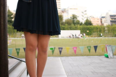 Low section of woman standing outdoors