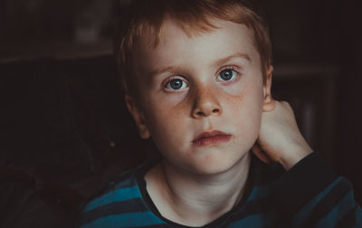 Close-up portrait of cute boy at home