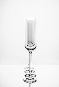 Close-up of wine glass on table against white background