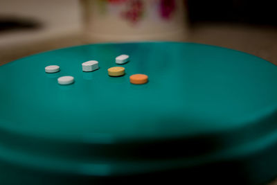 High angle view of pills on green stool