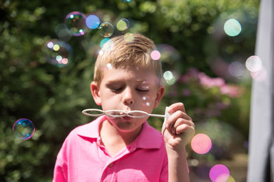 Portrait of girl with bubbles in mid-air