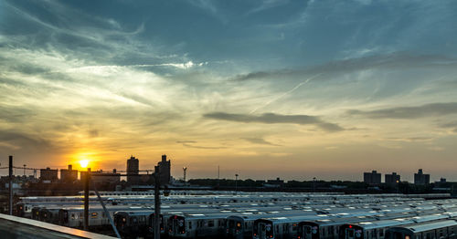 View of city at waterfront during sunset