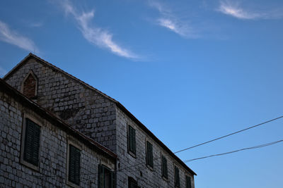 Low angle view of building against blue sky