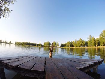 Pier on lake against clear sky