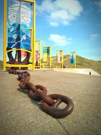 Close-up of snake on metal against sky