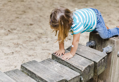 High angle view of child standing on wood