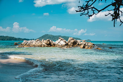 Empty, calm sandy crescent kalim bay, beach with turquoise blue clear water and cirrus cloudy sky