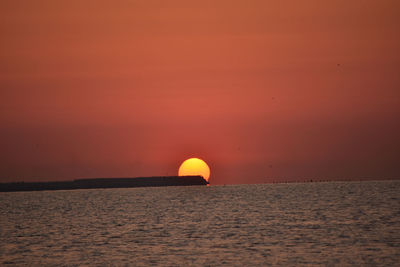 Scenic view of sunset over calm sea