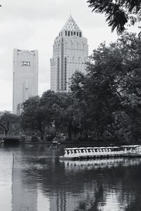 Reflection of trees and buildings in river