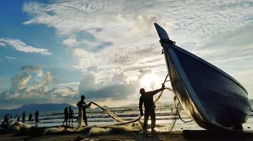 Man standing on beach against sky