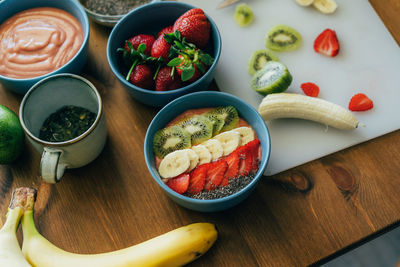 Bowls with ground fruit and berry healthy smoothies. ready-made dessert decorated with summer fruits