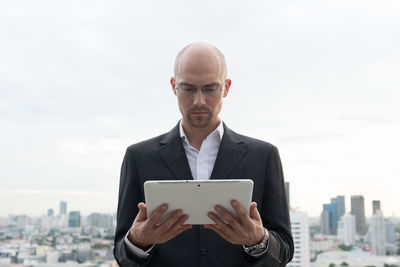 Man using mobile phone in city