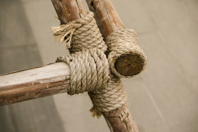 Close-up of rope tied on wooden post