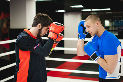 Men practicing in boxing ring