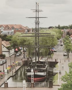 Boats moored at harbor against sky