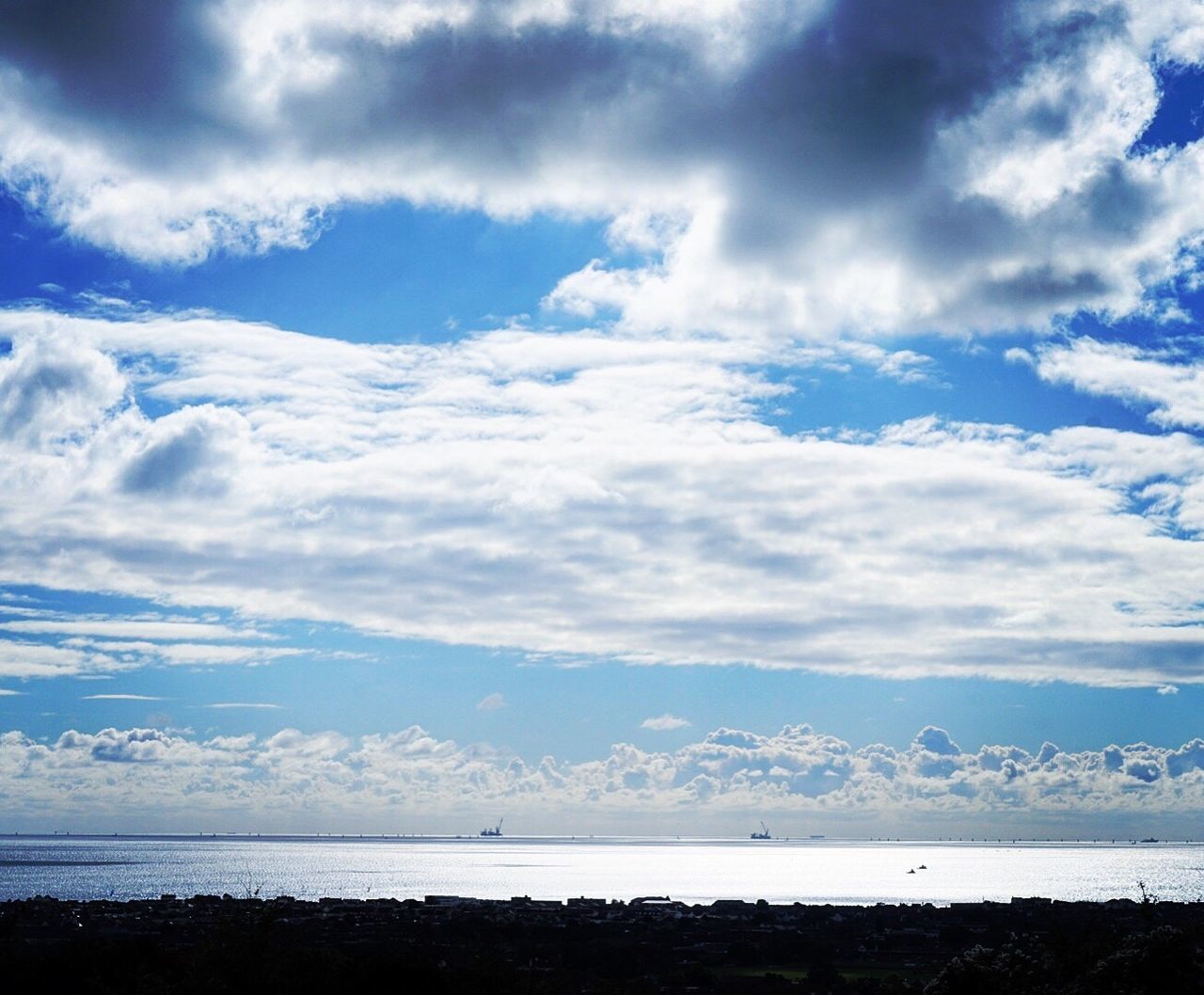 VIEW OF CALM SEA AGAINST CLOUDS