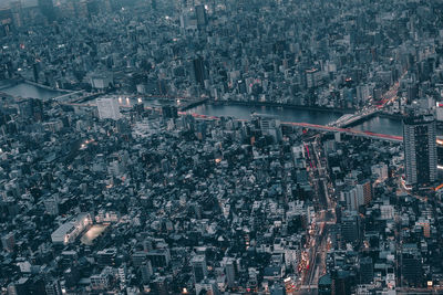 Aerial view of illuminated city against sky at night