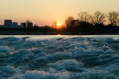 Snow covered landscape at sunset