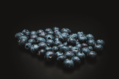 Close-up of blueberries against black background