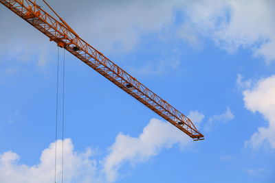 Low angle view of crane against sky