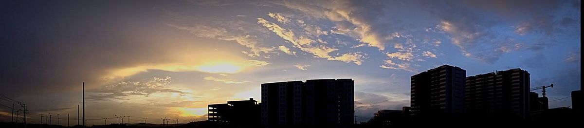 Low angle view of skyscrapers against sky during sunset