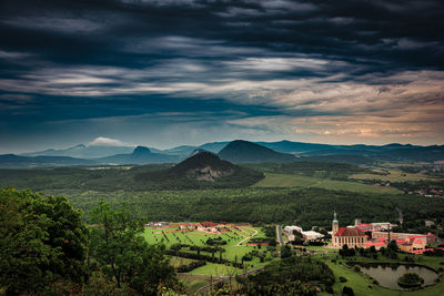 High angle view of townscape by mountains against sky