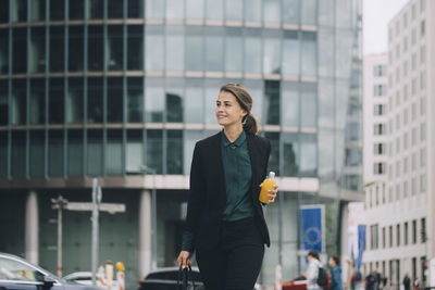 Young woman looking away in city