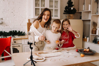 Portrait of siblings playing with toys at home