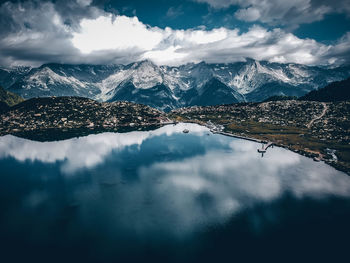 Aerial view of snowcapped mountains against sky