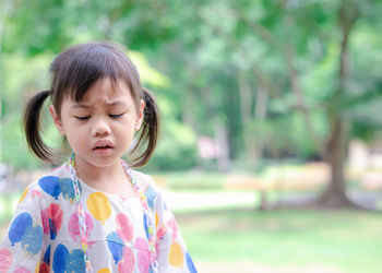 4 years old cute baby asian girl, little toddler child with pigtails hair making frustrated face.