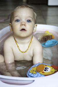 Portrait of cute baby girl in bathtub