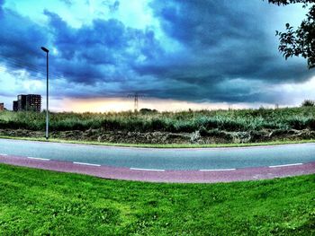 Scenic view of field against cloudy sky