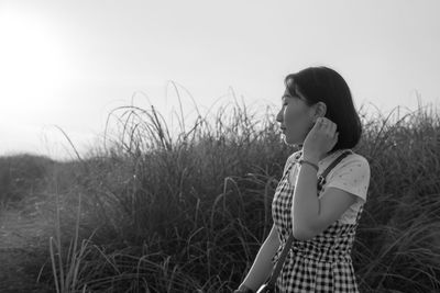 Woman standing against plants