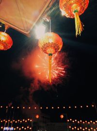 Low angle view of illuminated ferris wheel