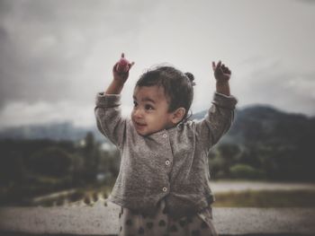 Portrait of cute boy standing outdoors