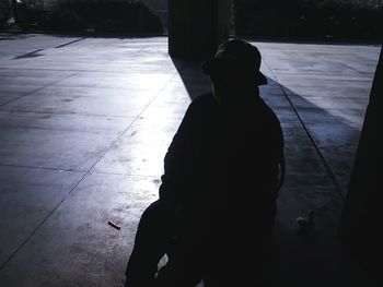 Rear view of a silhouette man in water