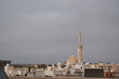 Buildings in city against sky