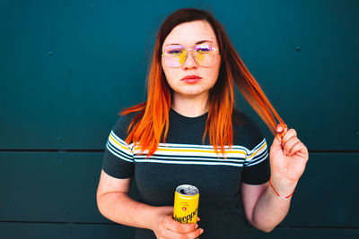 Portrait of beautiful young woman drinking drink